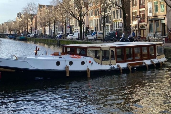a small boat in a body of water with a city in the background