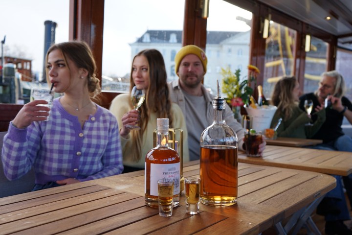 a group of people sitting at a table with wine glasses