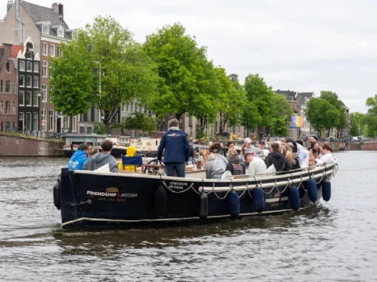 a group of people in a boat on a body of water