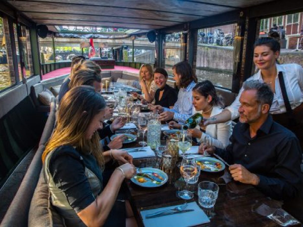 a group of people sitting at a table in a restaurant