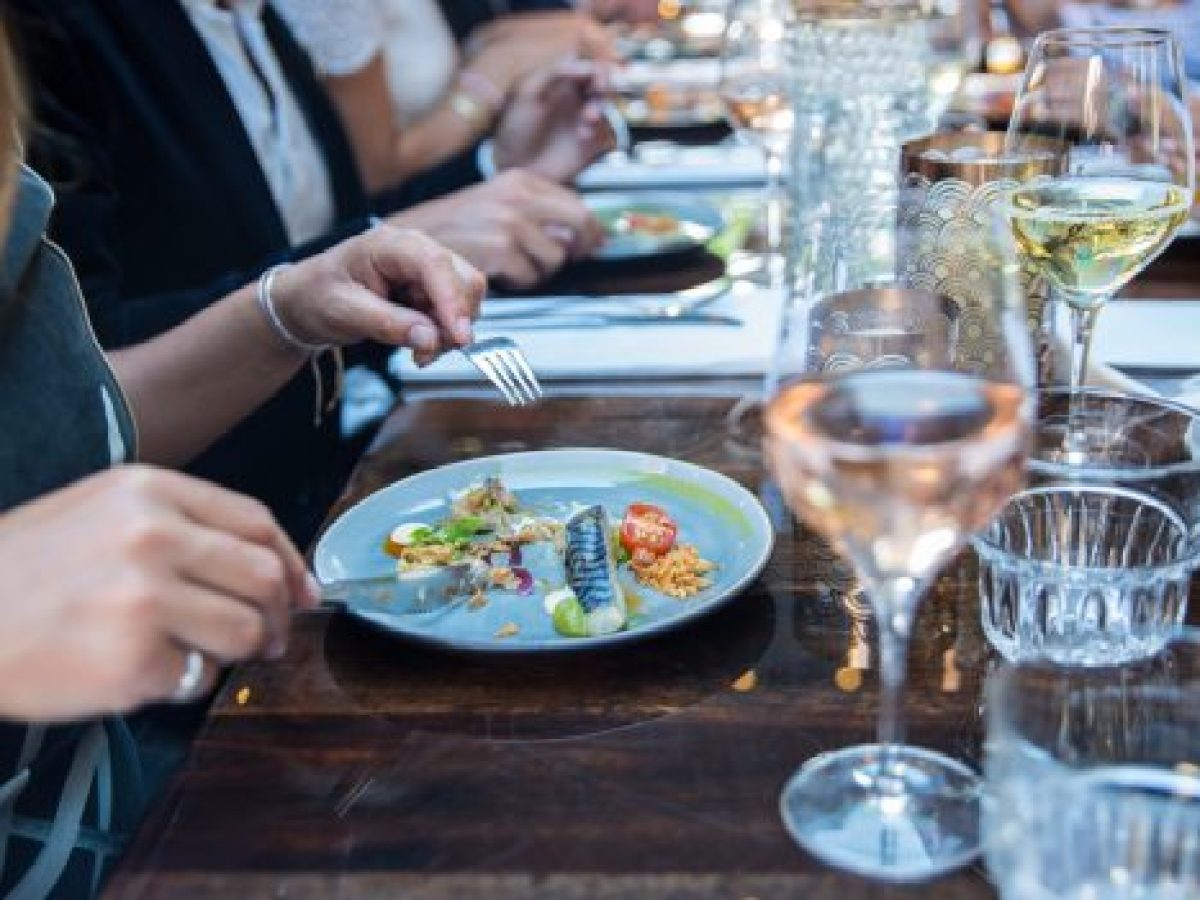 a group of people sitting at a table with wine glasses