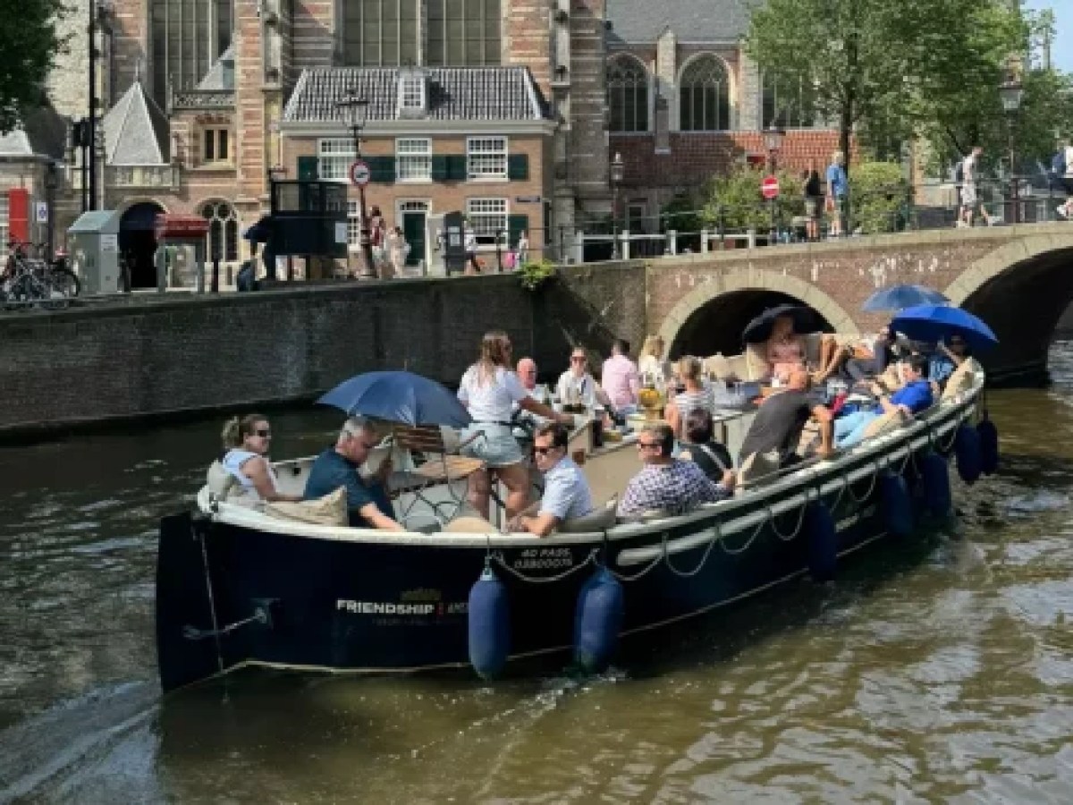 a group of people in a small boat in a body of water