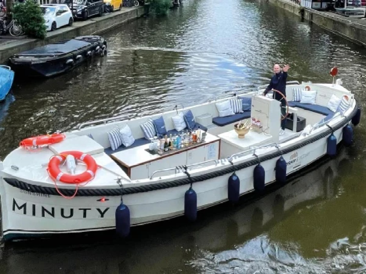 a boat floating along a river next to a body of water