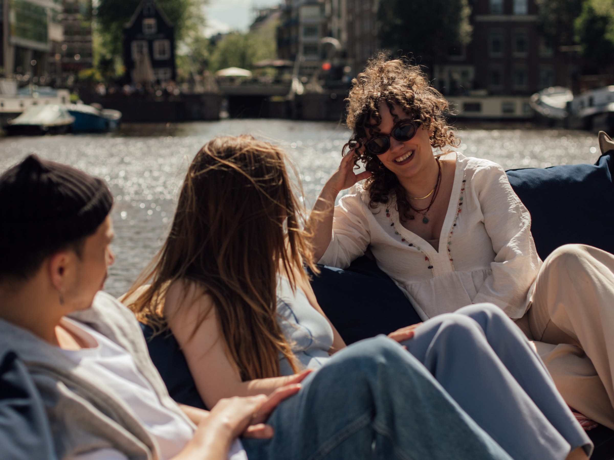 a group of people sitting in a chair talking on a cell phone