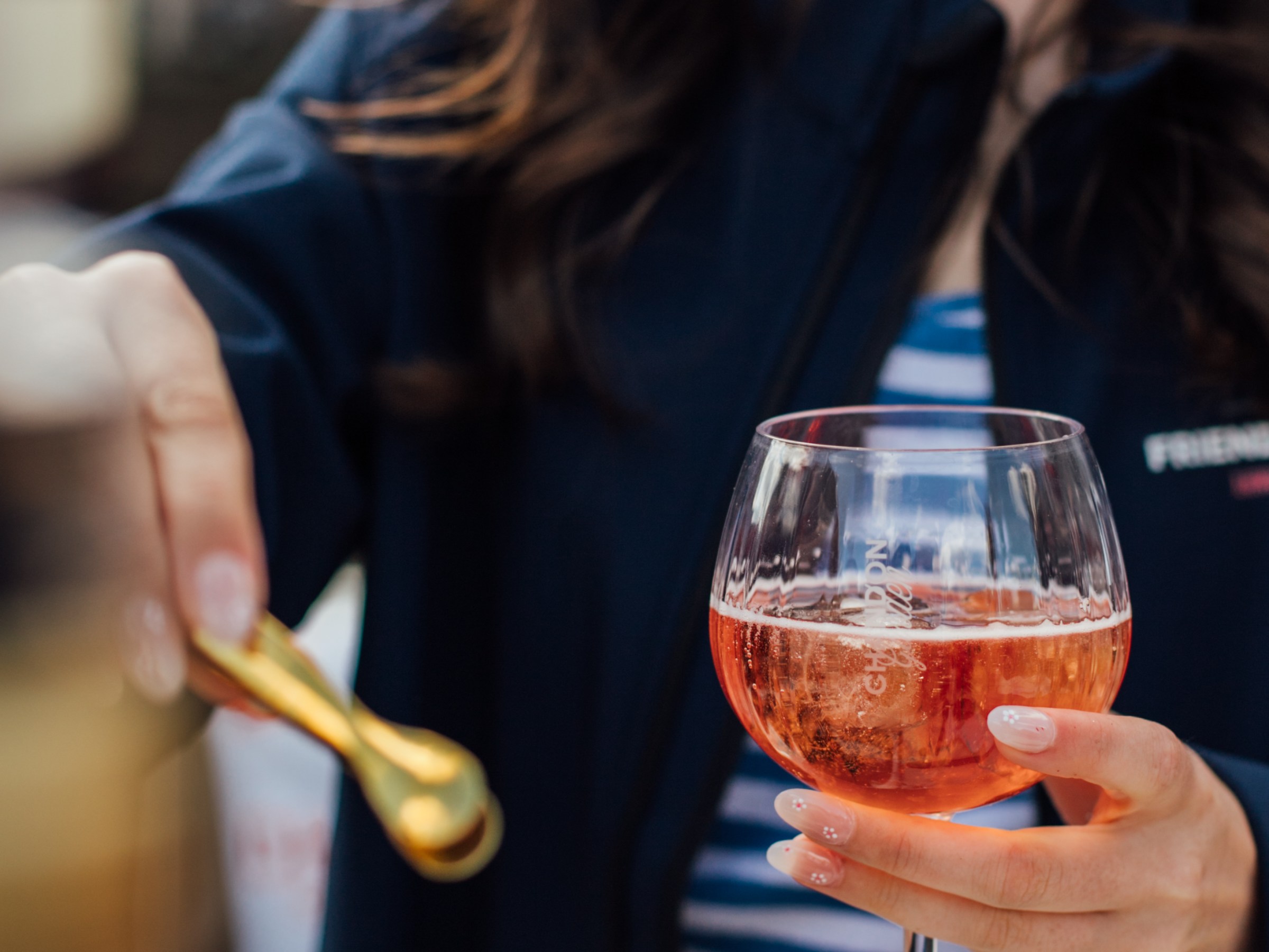 a woman sitting at a table with wine glasses