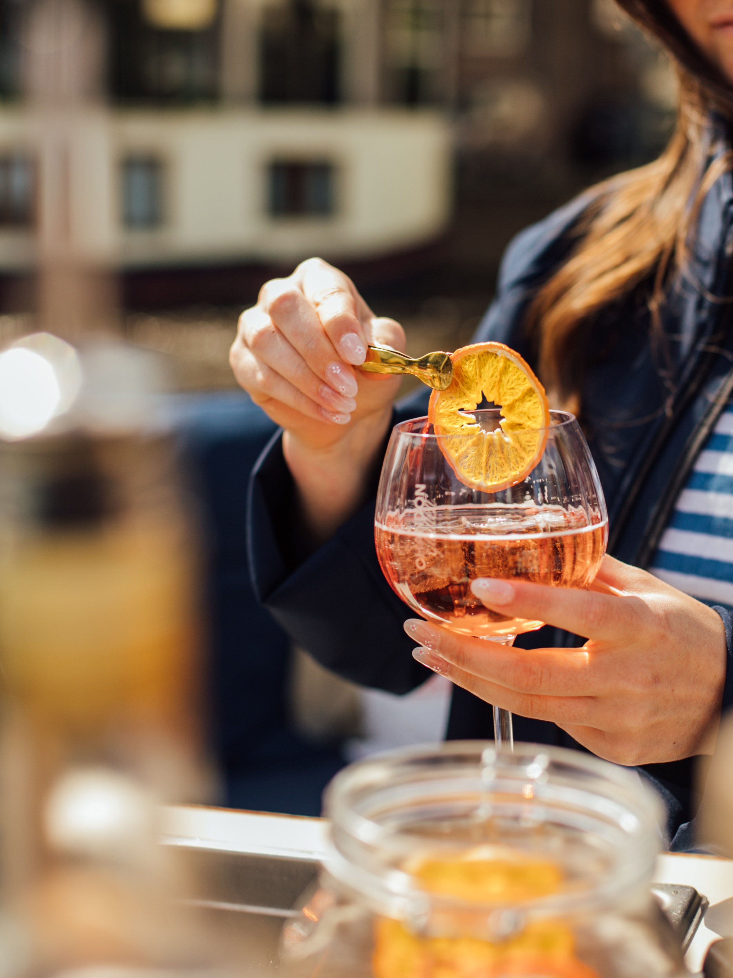 a person sitting at a table with wine glasses