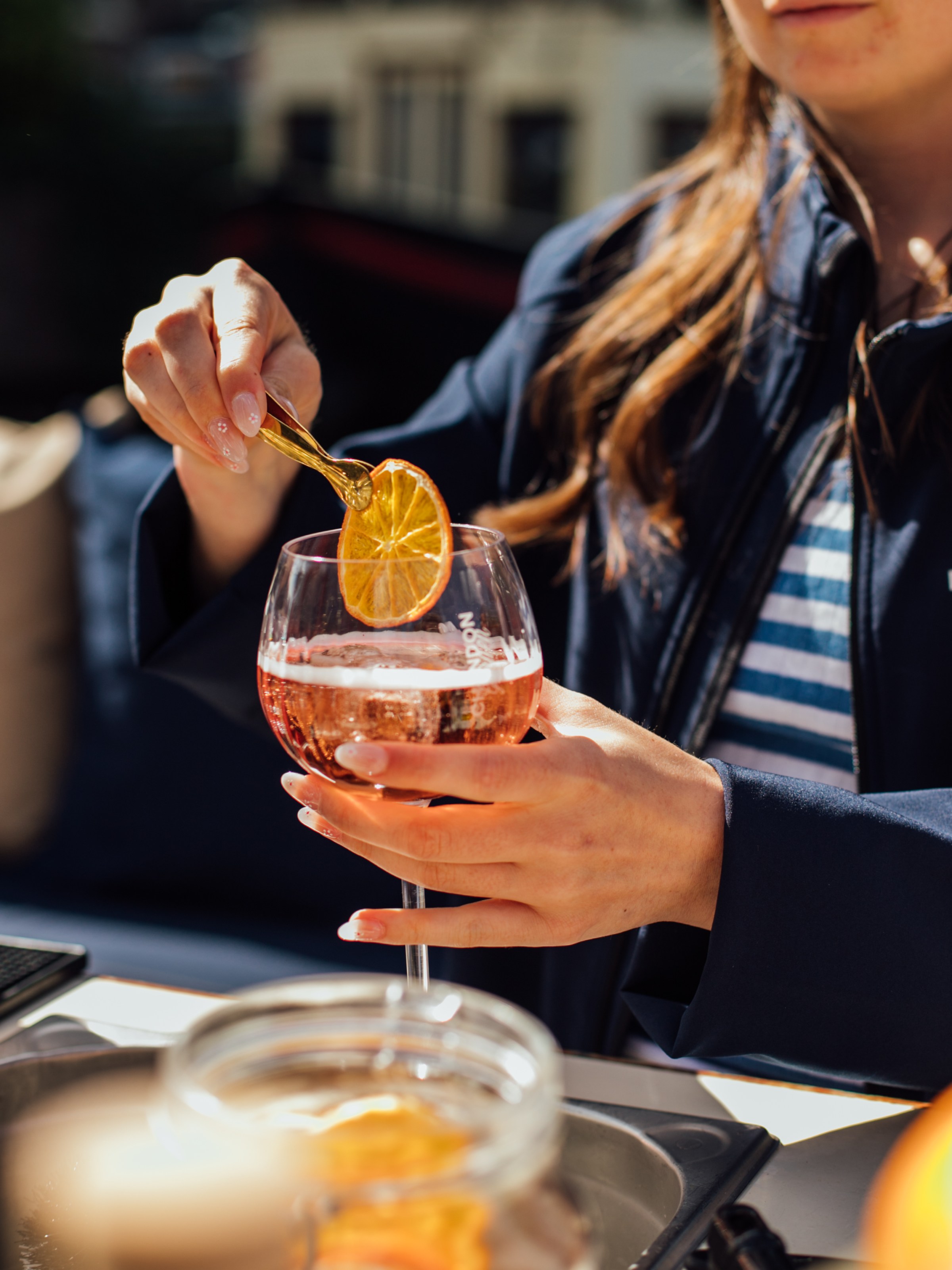 a woman sitting at a table with a glass of orange juice