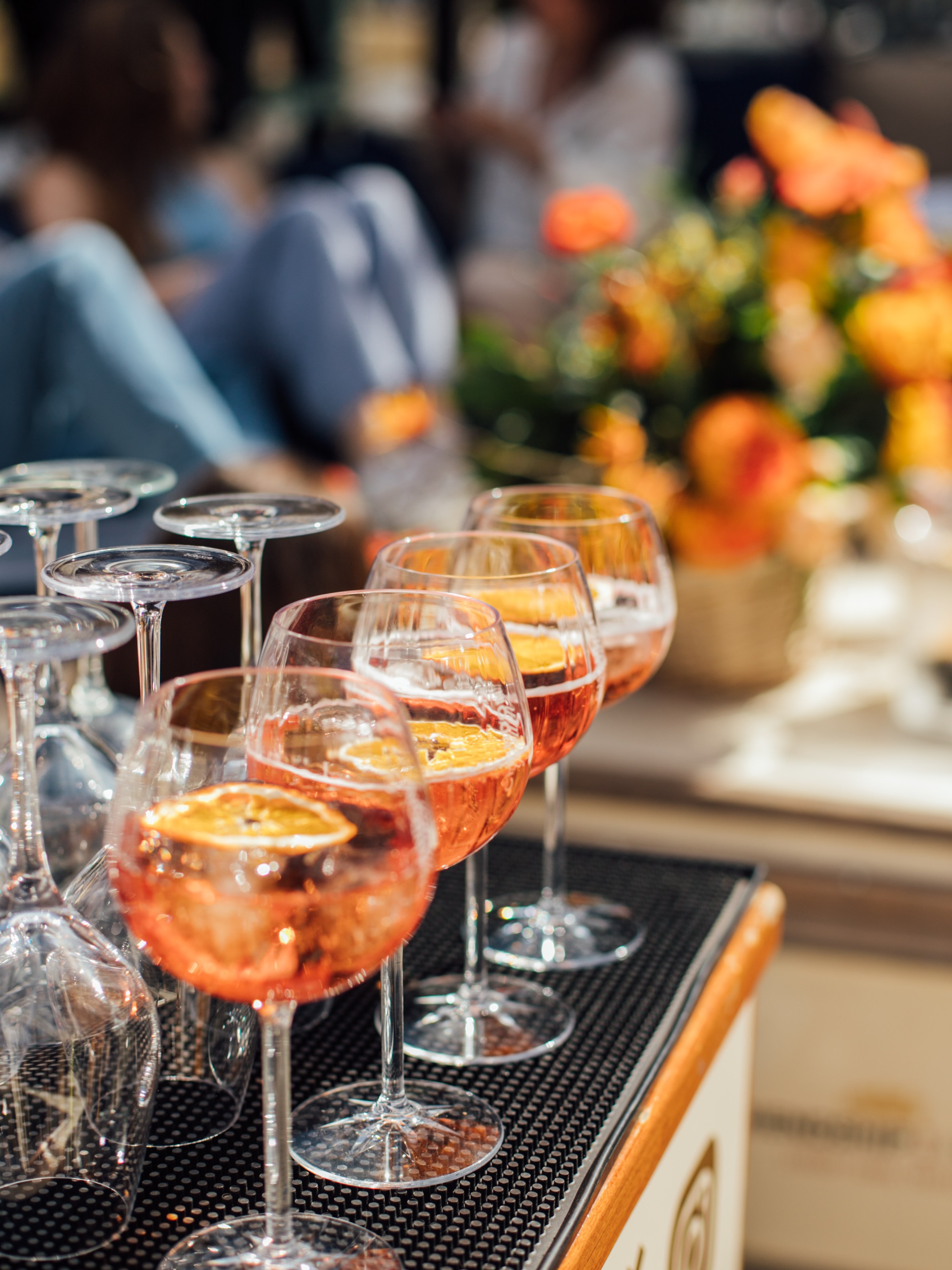 a person sitting at a table with wine glasses