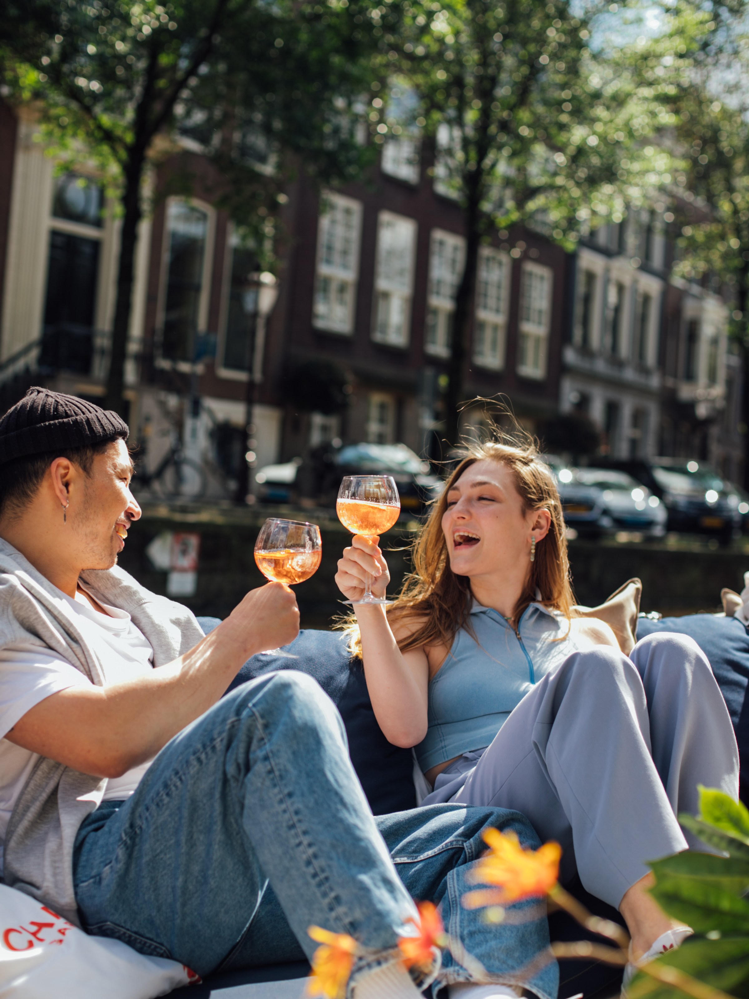 a group of people sitting in a chair talking on a cell phone