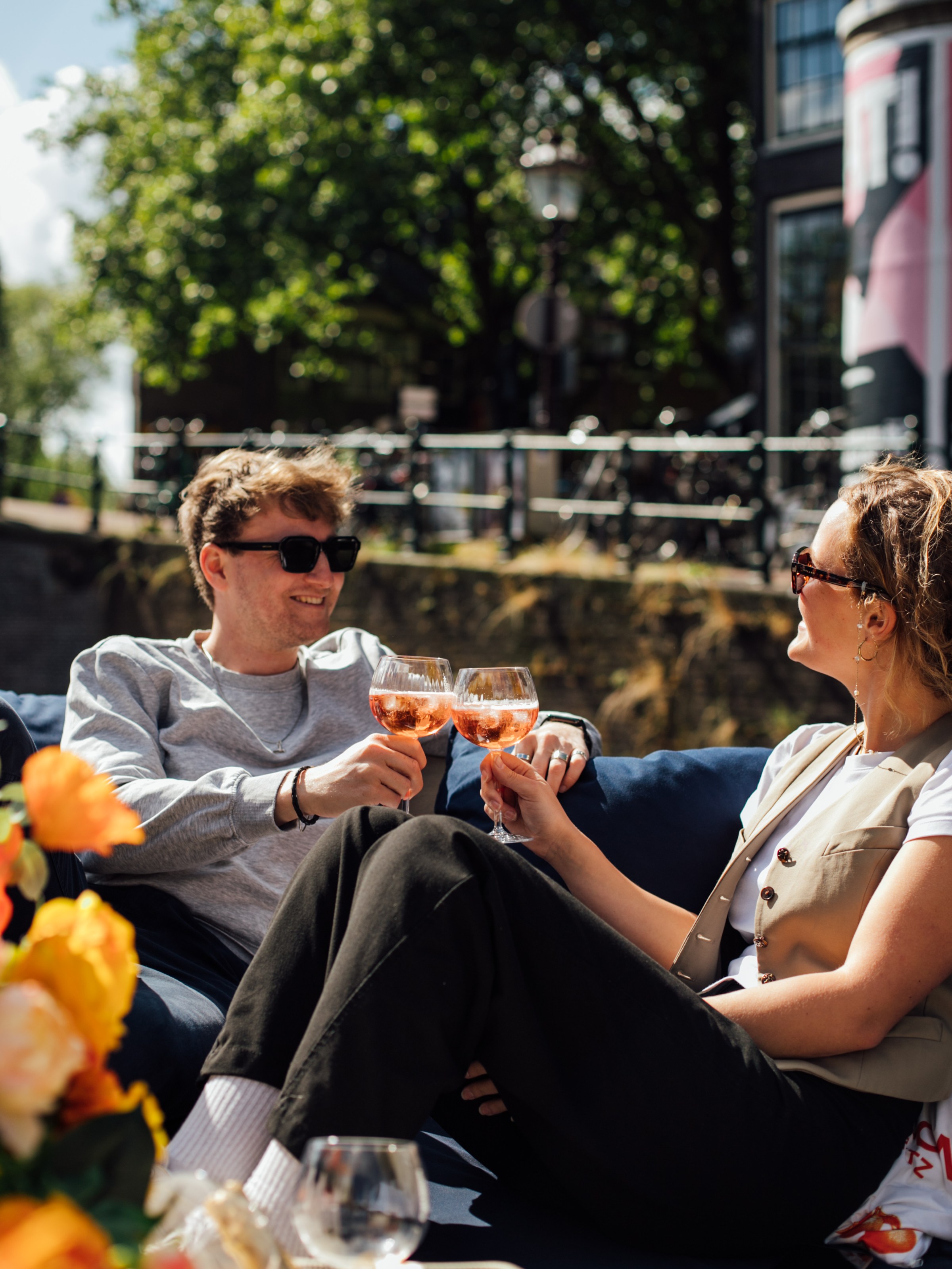 a group of people sitting in a chair talking on a cell phone